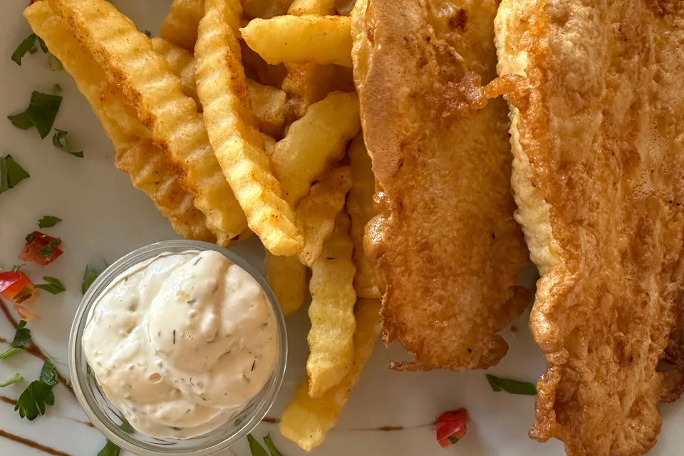 Example photo: Battered fish fillets with crinkle-cut chips and a small bowl of sauce